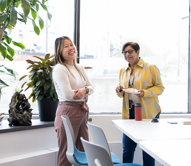 Two women being happy in office