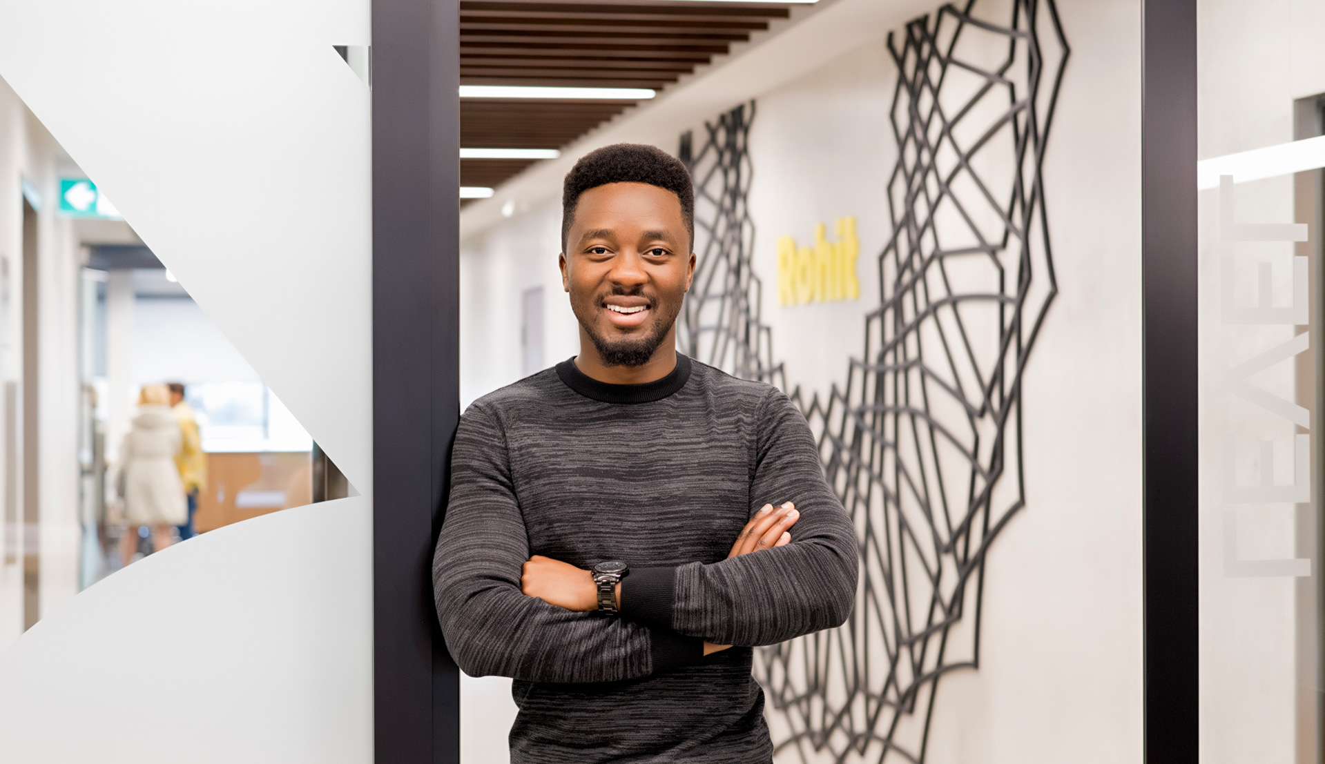 Man standing in hallway with a smile.