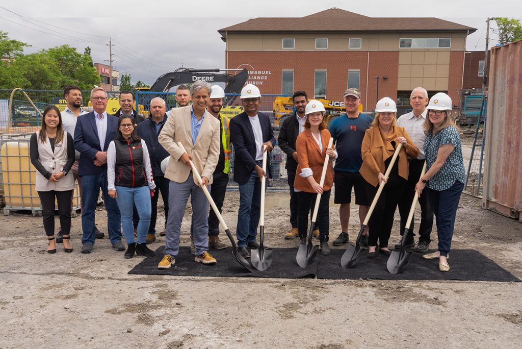 Rohit team holding shovels ready to break dirt in Ottawa community.